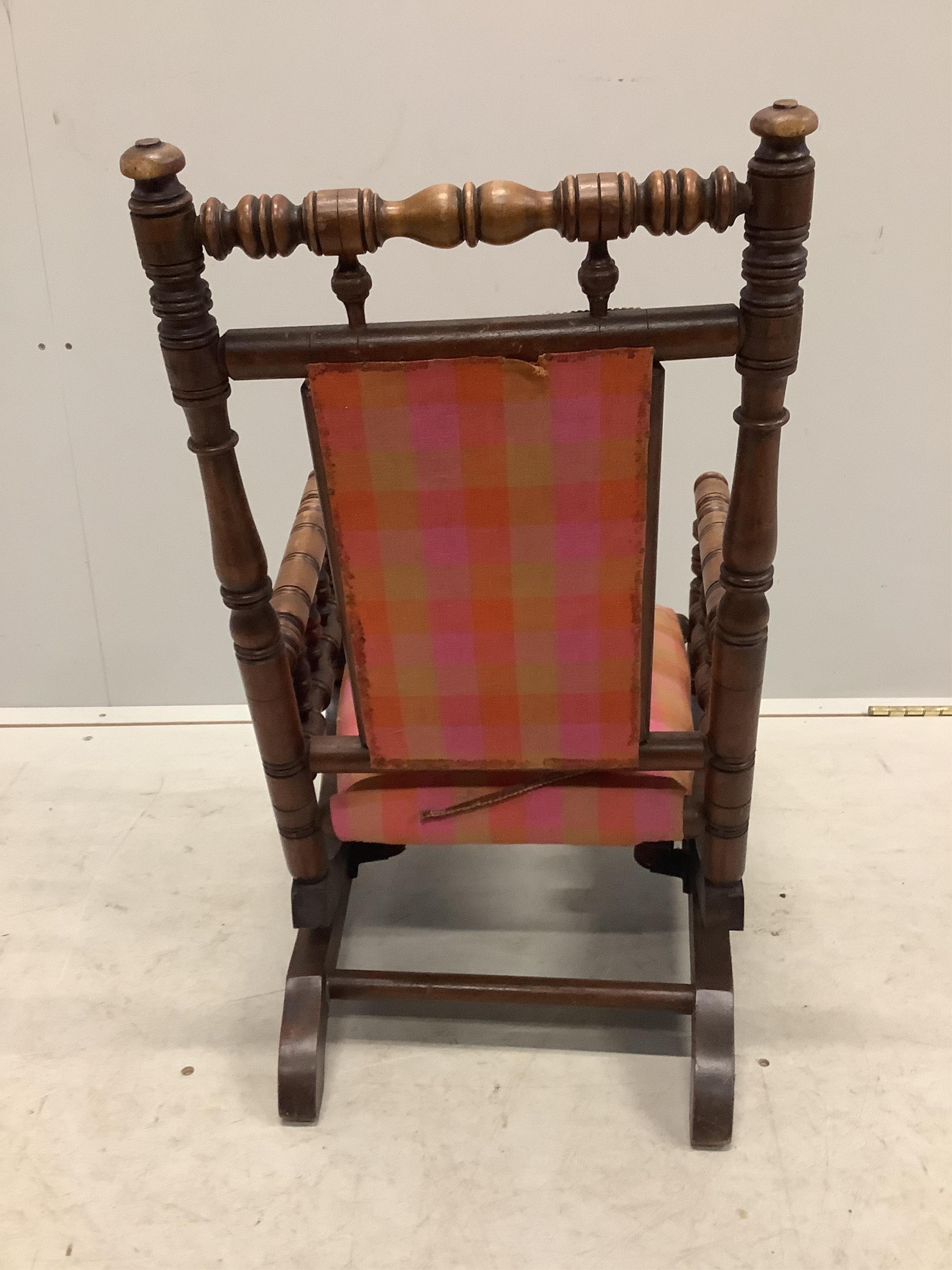 A late 19th century American turned beech child’s rocking chair, width 39cm, depth 49cm, height 66cm. Condition - fair